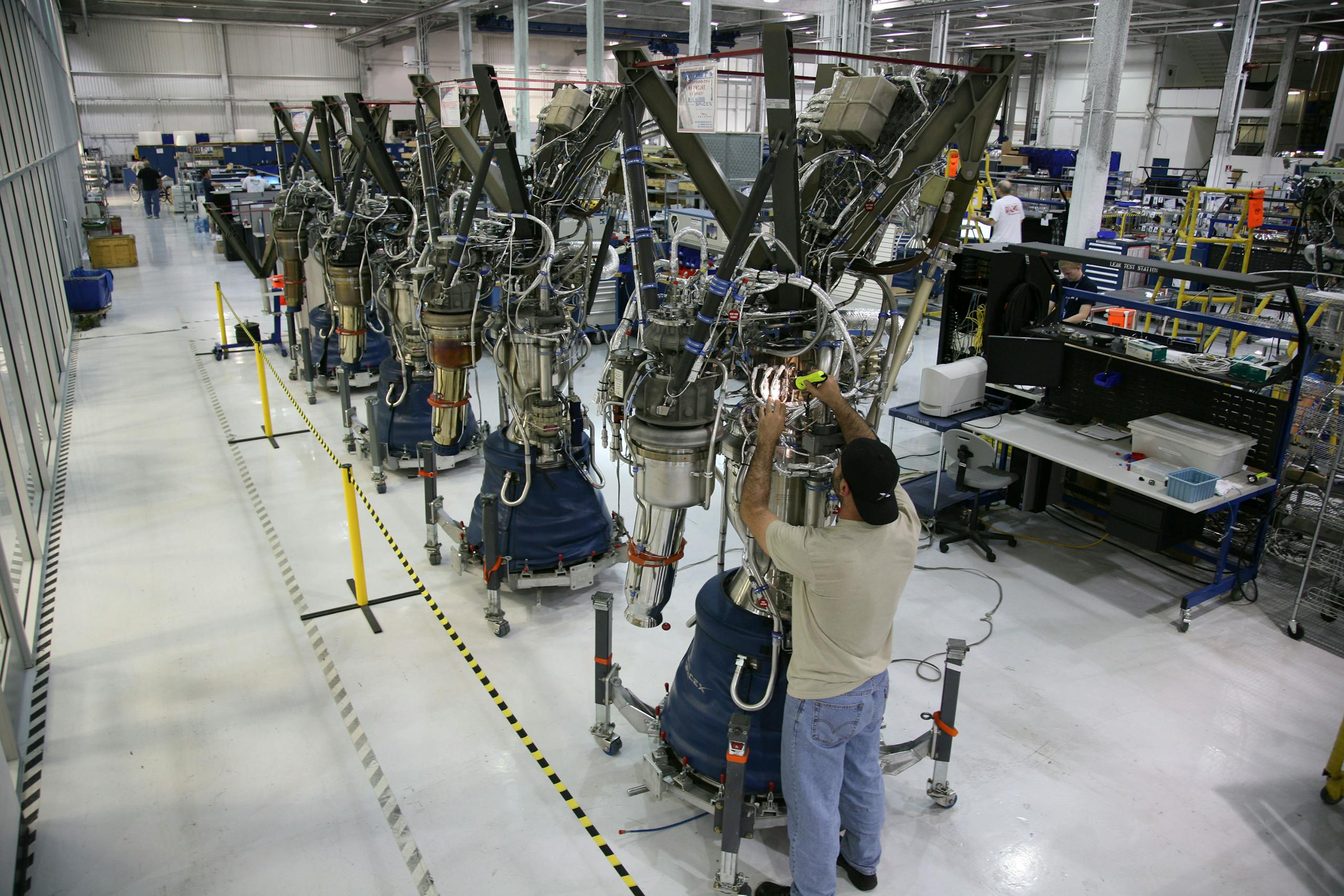 Anonymous mechanic fixing rocket details during assembly