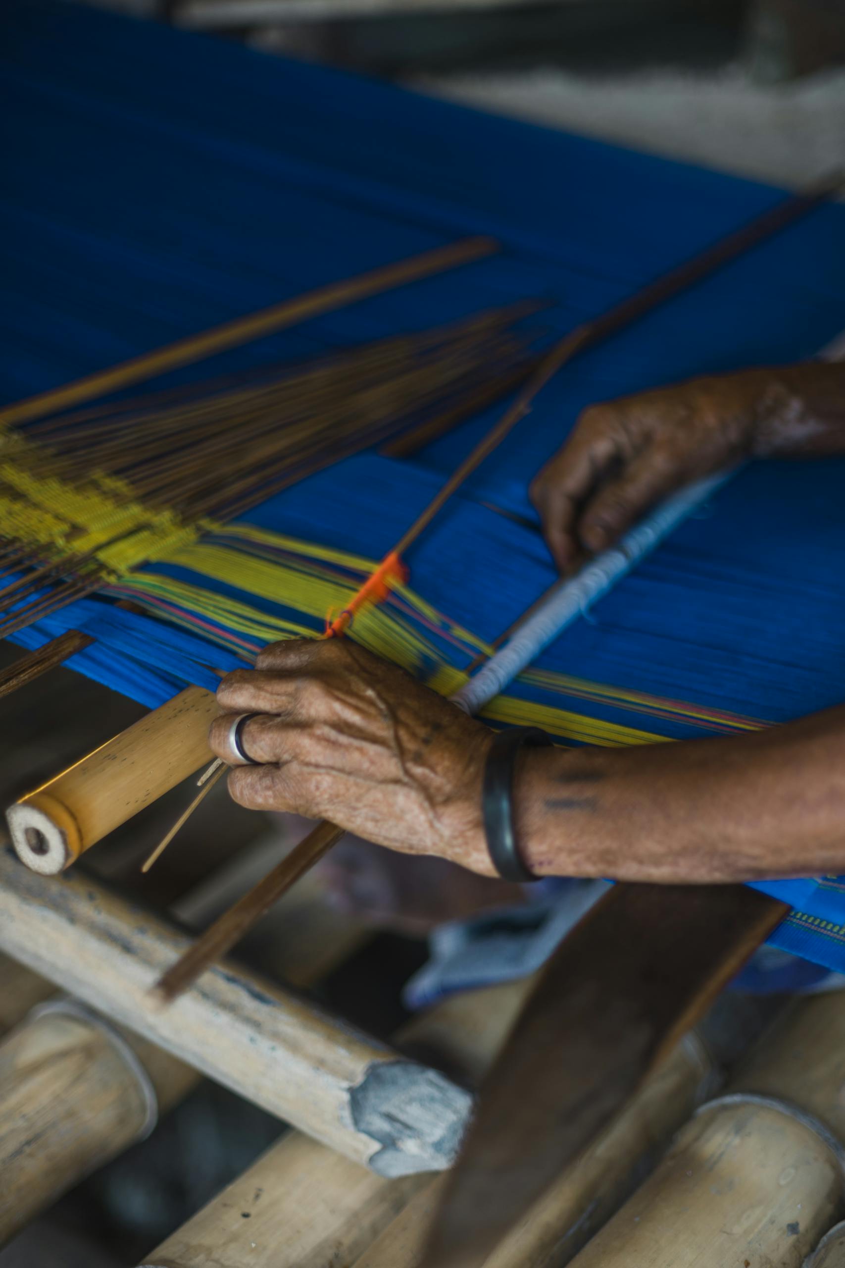 Person Holding Yellow and Brown Stick